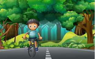 Хлопчик у шоломі їде на велосипеді по дорозі